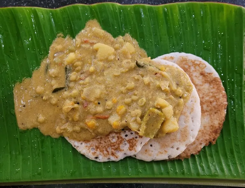 A vegetarian meal served on a banana leaf