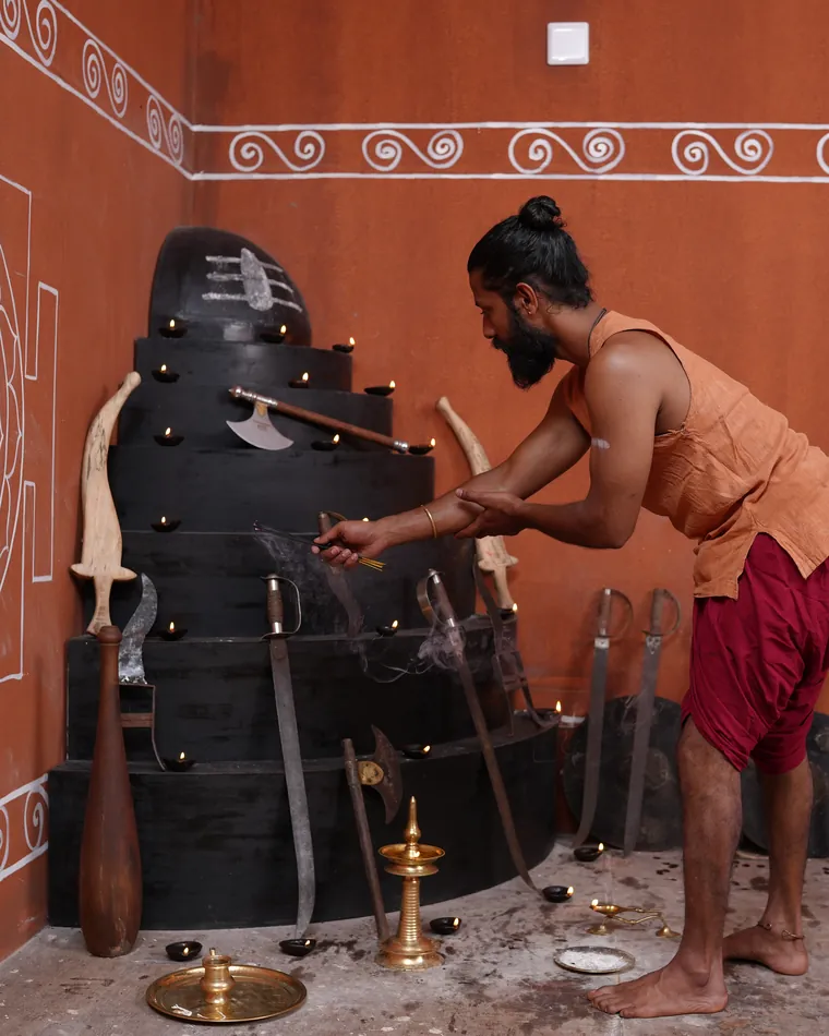 Ashan Vipin Das at the poothara, the stepped shrine in the corner of the kalari