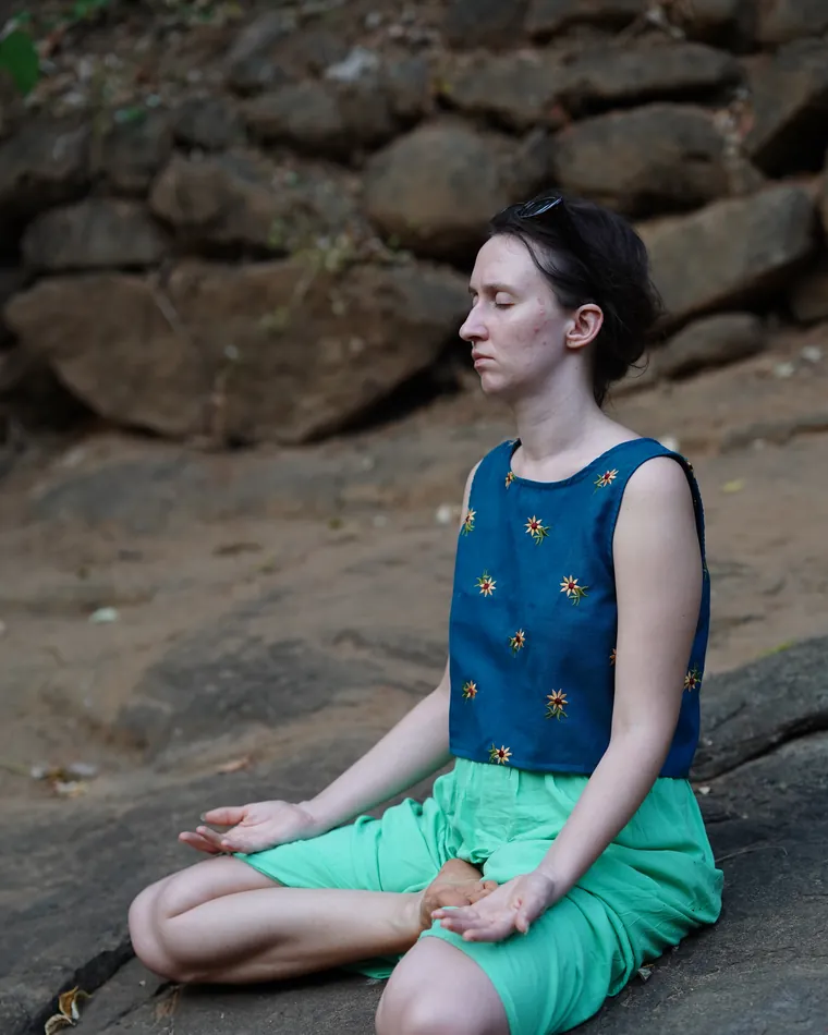 A Kalaripayattu student sitting in meditation at Athma Kalari